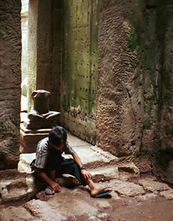 a cambodian young boy waiting for the next traveler to earn some money